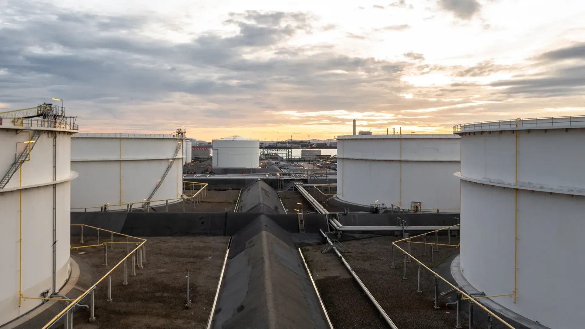 Storage tanks and pipework at sunset at Khorfakkan
