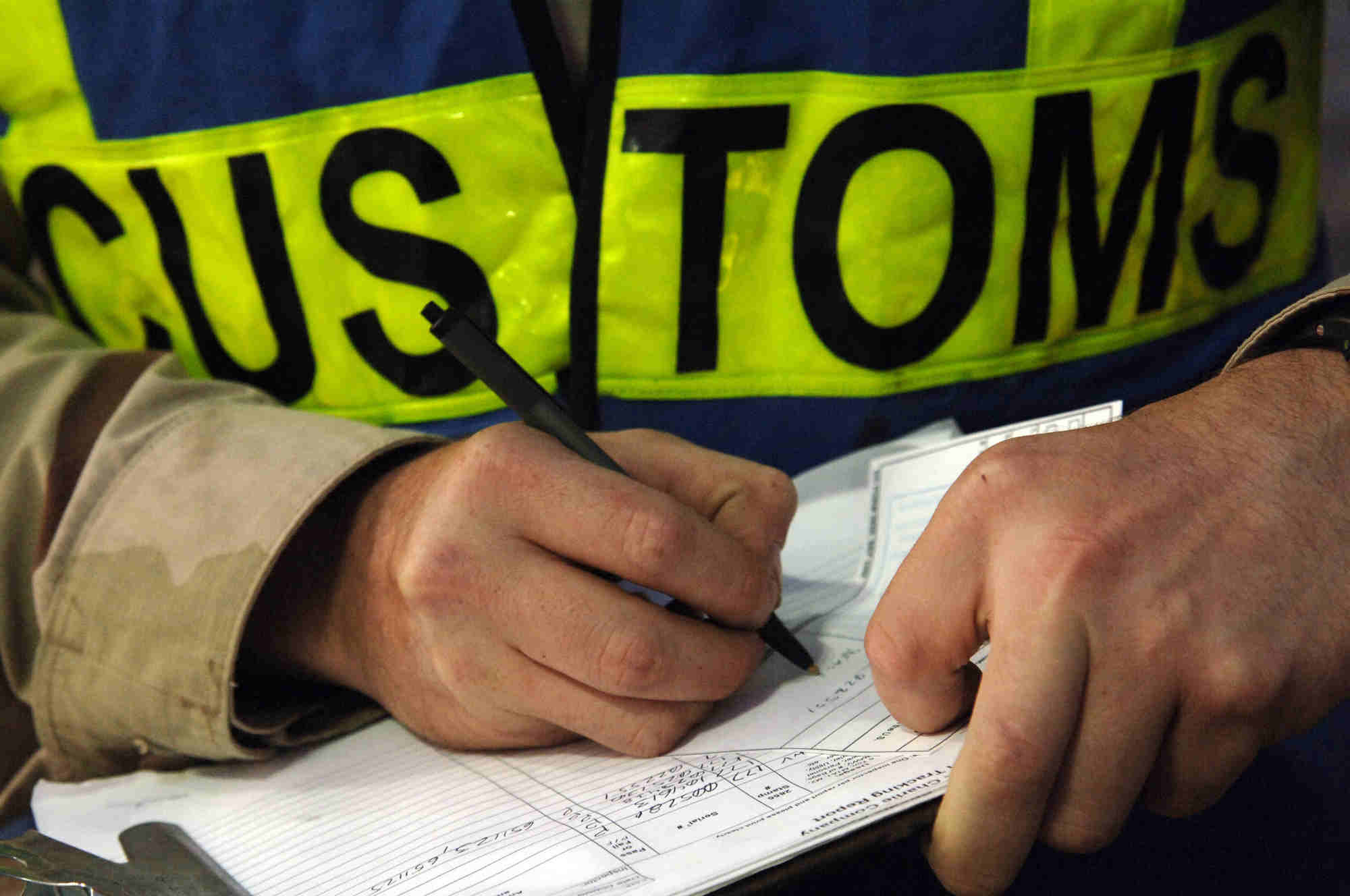 Customs officer completing cargo clearance paperwork