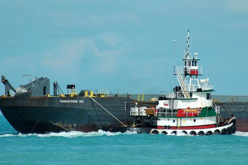 Tug alongside a barge at sea