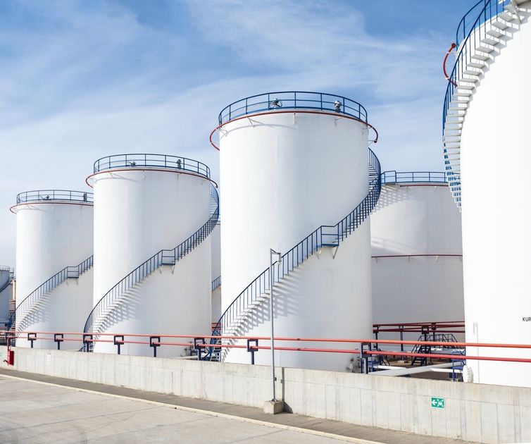 White oil storage tanks with external stairs at a Jeddah terminal