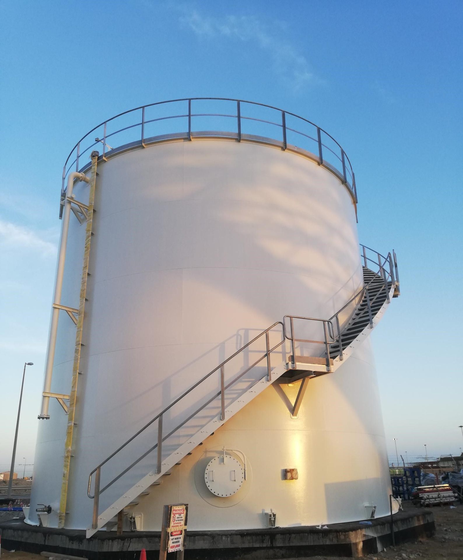 White storage tank with spiral access stairs at Yanbu