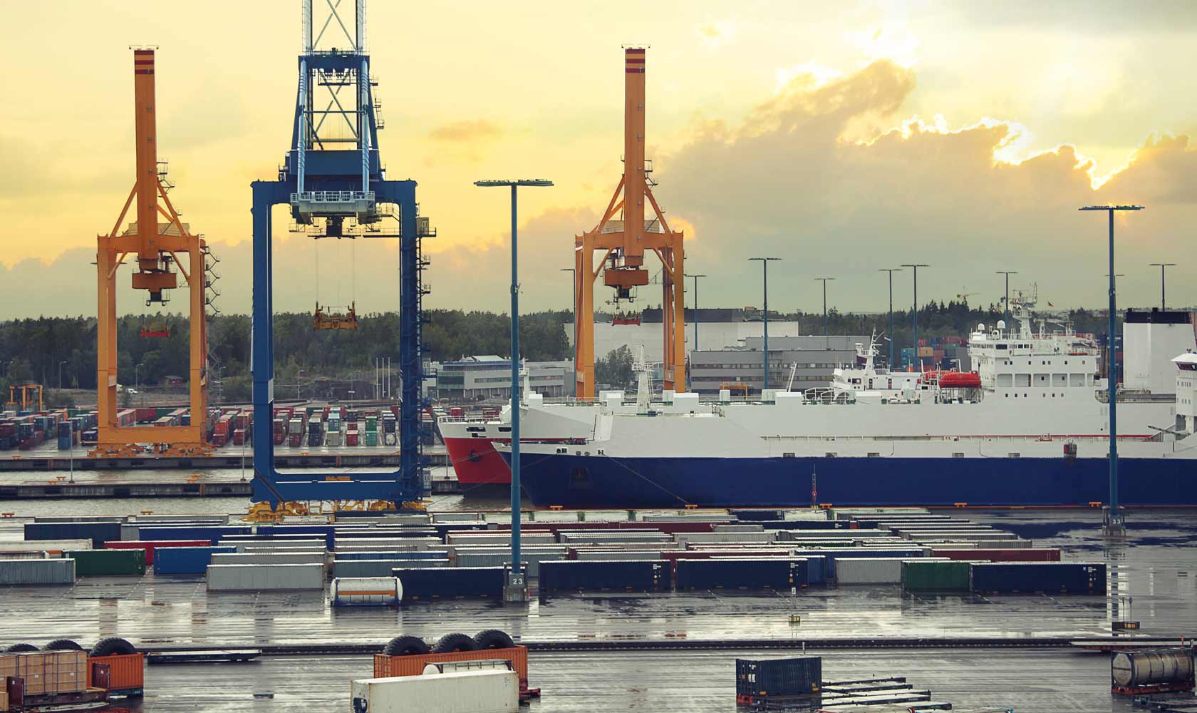 Quayside cranes and a berthed vessel at a container port